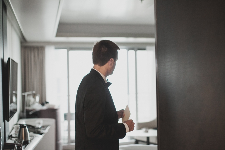 groom and bride getting ready together in the same room