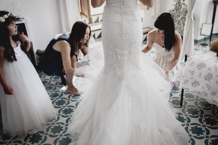 bride putting on her dress