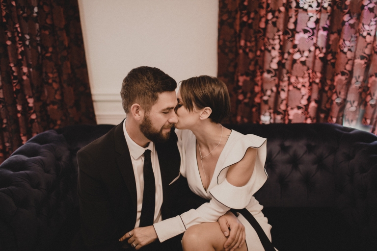 bride and groom kissing each other.