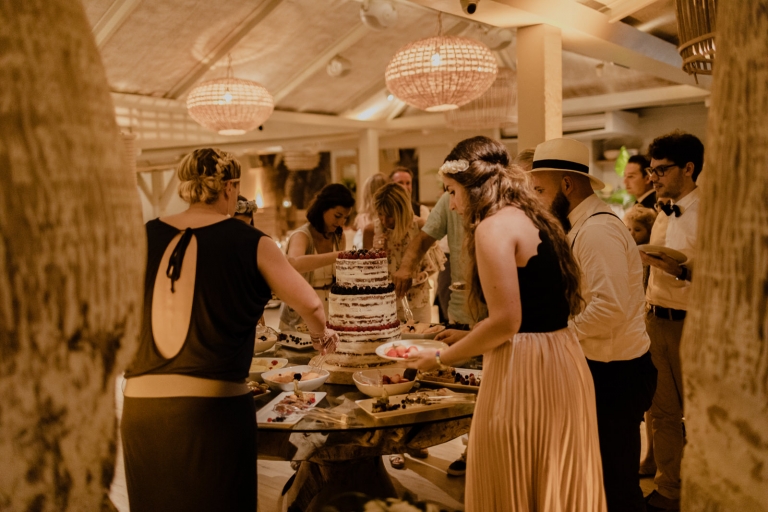 the wedding couple cutting the cake