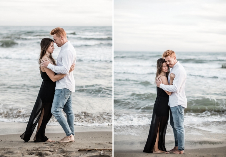 photo of the couple standing on beach sand 